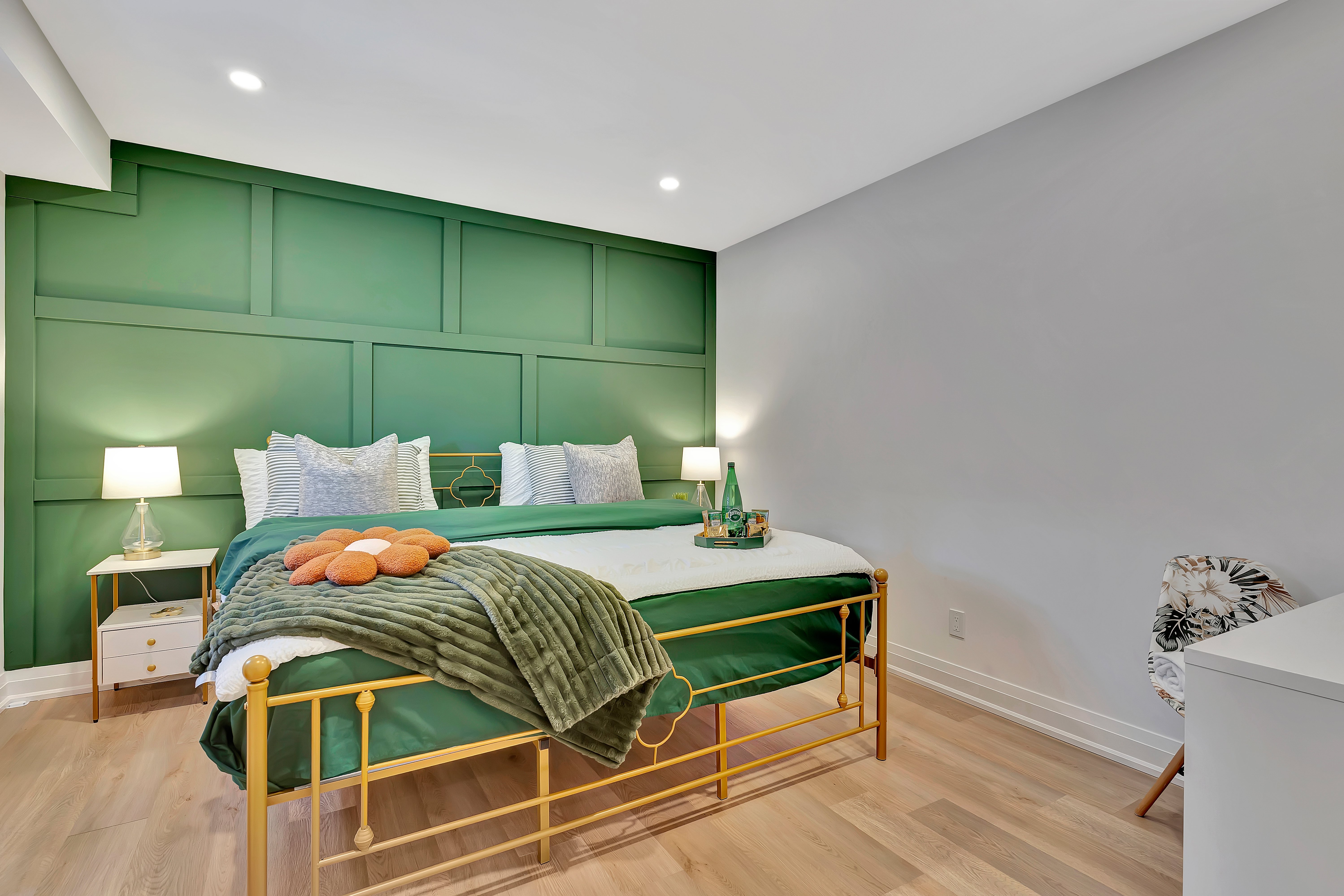 Master bedroom with emerald feature wall and gold bed