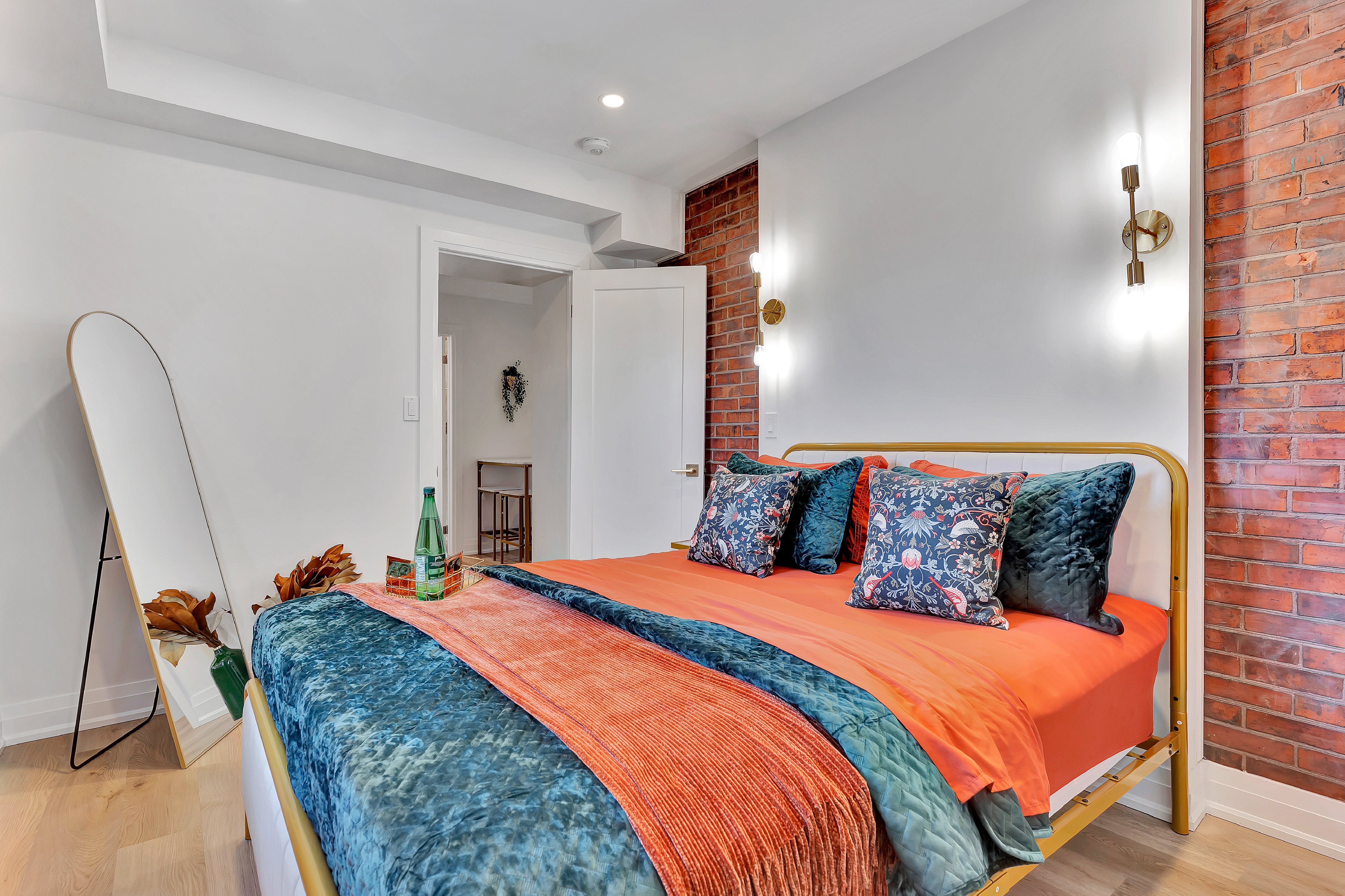 Second bedroom with exposed brick and Stratford Festival art