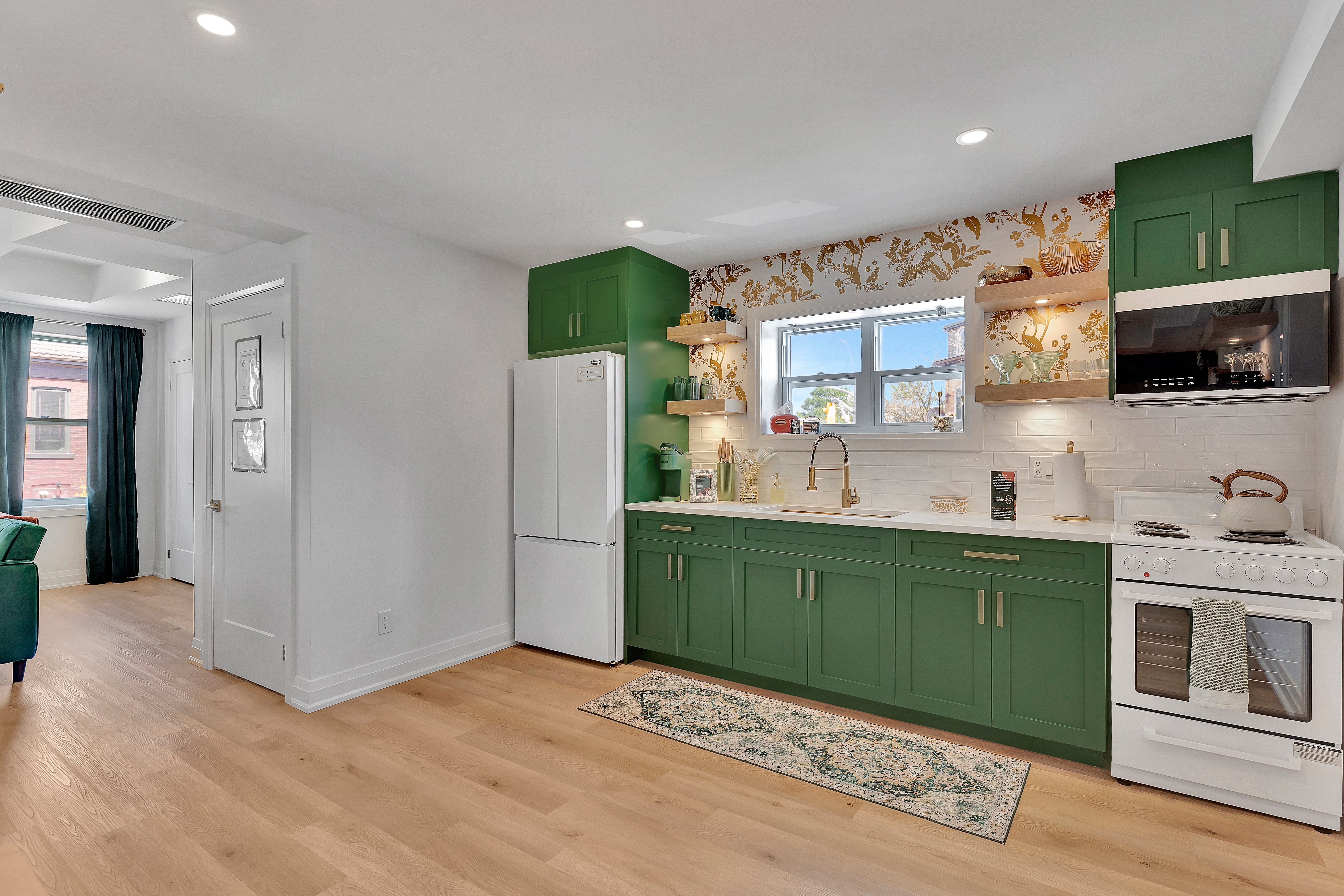 Full kitchen with emerald green cabinets
