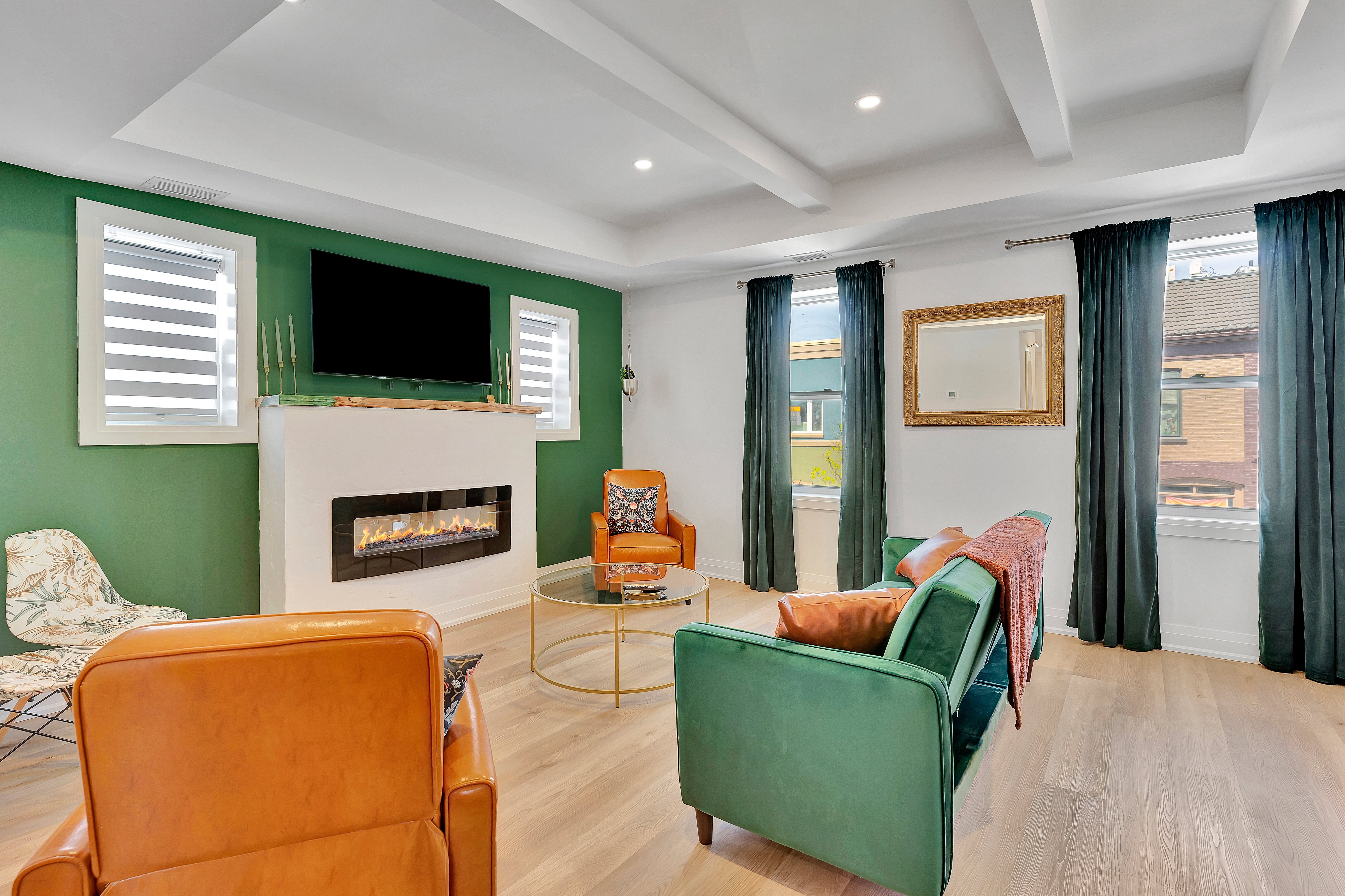 The Saint Patrick luxury suite living room with emerald green fireplace wall